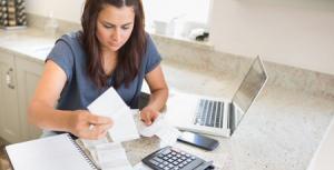 photo of a spouse paying monthly bills using income collected through spousal support from her ex husband